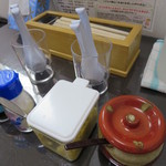 留さんうどん - 卓上。手前は、どきどきうどんアイテムのおろし生姜と鷹の爪