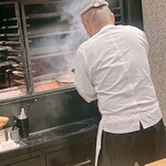 薪鳥新神戸 - 網にてんこ盛りしたそぼろを巻きで焼き上げます