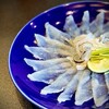 春帆楼 - ふく薄造り。地元山口の安岡ネギを巻いて…