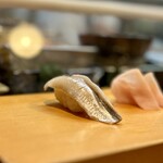 寿し辰 - ツナシ。
      これ、小さめのコハダのことをそういうらしい。
      前回のレビューでイワシ？って書いたのと同じやつ。やっぱりコハダでした〜(^◇^;)  コハダの皮を引いてるのね！  イワシじゃなかった〜笑笑