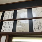 らーめん小国 - サインが敷き詰められてる一部　きみまろー