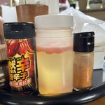みなと食堂 - 料理写真:卓上の調味料（燃辛唐辛子、コーレーグース、七味唐辛子）