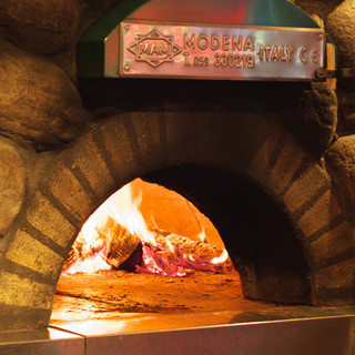 Stone oven pizza baked over charcoal