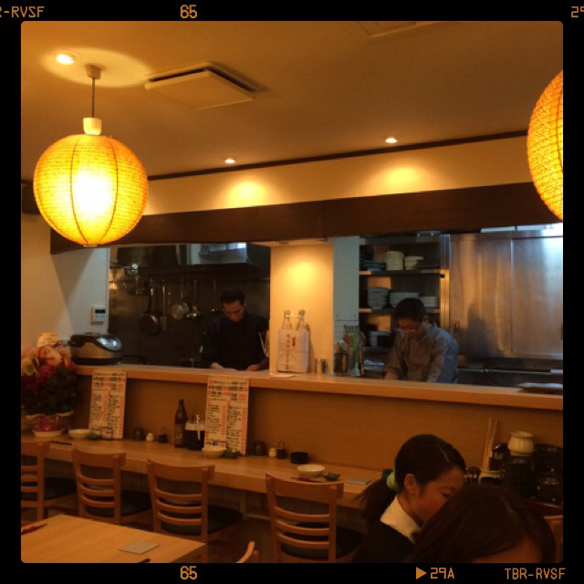 A person enjoying a meal in a warm, relaxed setting that can be paired with nutrient planning for overall health.