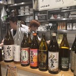 食堂うめぼし - 芋焼酎が並んでます