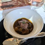 Une Fleur - ロワイヤル：ボルチーニ茸、ヒラタケ etc．木ノ子色々のコンソメロワイヤル（洋風茶碗蒸し）軟らかく煮込んだ牛タン載せ。