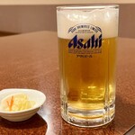 藤十飯店 - 最初いただいた中生。　お通しの白菜漬け。