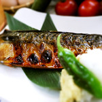 Salt mackerel set grilled over open fire