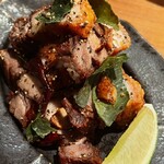 BIANCHI - 皮付き豚バラ肉のニンニク黒粒胡椒炒め。ライムが嬉しい
