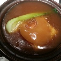 華都飯店 OsakaMetro本町ビル店 - フカヒレの姿煮です。フカヒレのスライスがお焦げの上に載っています。１人ずつ小鍋に入ったフカヒレをスープとともにいただいて幸せです。