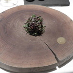 オマージュ - サーモンをライムソースで頂きました。
      料理が冷めないように木の上にのせて、食べる時には、木を外して頂きます。