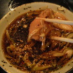 そば処港屋 - 鳥そばのつけ汁に鶏肉が2つ入っていました。結構大きいです。ネギは斜め切りでスープはラー油も効いててパンチあります。