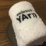 SHOKUDO YArn - ロゴ入りのおしぼり。