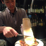 cheese dining K-style - ラクレットチーズを目の前で削ってくれてる