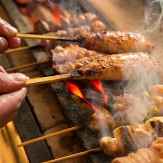 A selection of delicacies including charcoal Yakitori (grilled chicken skewers), special horse meat sashimi, and addictive chicken dish.