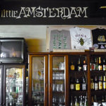 リトルアムステルダム - ドリンクカウンター向こうの棚にはたくさんのお酒とお店のロゴが。