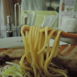 麺は平打ち中太ストレート丸麺。高加水率で、透けて見える粒は「亜麻仁(アマニ)」らしい。