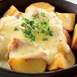 Grilled potatoes with melty cheese