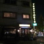 イル・パチョッコーネ・カゼイフィーチョ - 夜の店舗外観、縦看板がイタリアの雰囲気を。