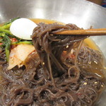 손수반상 - しっかり味付けされたスープにそば粉が入った黒っぽい適度なコシの麺、サッパリしたヨルム(若大根)キムチが特徴の韓国冷麺です。