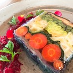 Colorful vegetable terrine with raspberry and fermented paprika sauce