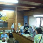 谷川米穀店 - お店の入口から店内を撮りました。 左手が座って食べるスペースで右手が調理スペースとなっています。