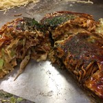 Hiroshima Okonomiyaki Dokkoi - 目の前の鉄板の上でカット