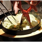 辛ちー鍋 とんがらし - 辛ちー鍋に火が通ると、店員さんがハサミでじょきじょきと。