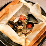 Seafood aqua pazza wrapped in paper