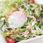 Caesar salad with warm egg and bacon