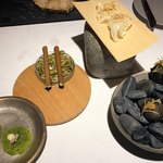 ラ・ヴァガボンド - 右から、子豚のテリーヌをイカ墨のベニエで包み揚げた品、子豚のコラーゲンをチップス状に揚げた品、ポルチーニ茸とクッキーを丸めて焼いた品、ほうれん草とツルムラサキのシフォンケーキ