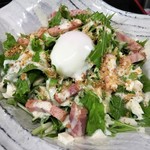 Caesar salad with warm egg and bacon