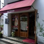 ラ・グラッツァ - お店の入口です。 頭上の幌の色が良いです。