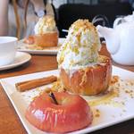 Whole baked apple topped with vanilla Ice cream, crumble and caramelized ginger sauce