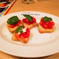ブルーオーシャングリル - お通し　ガーリックトマトのブルスケッタ